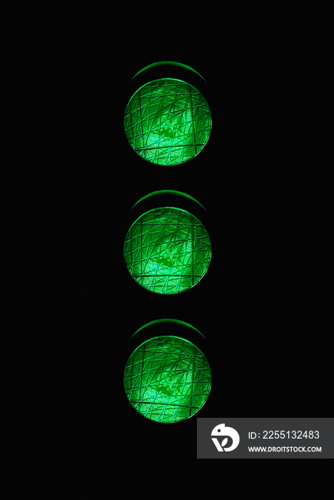 Traffic light with three green lights illuminated