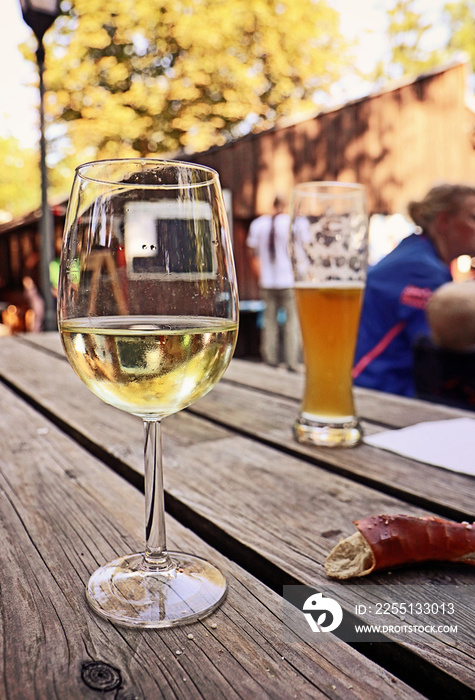 September in biergarten: a beer, a glass of white wine and salty bread, typical Bavarian