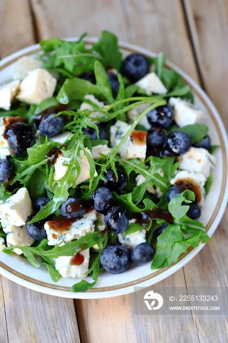 Delicious salad with blueberries and arugula. Fresh menu. Beautiful food. salad trend.