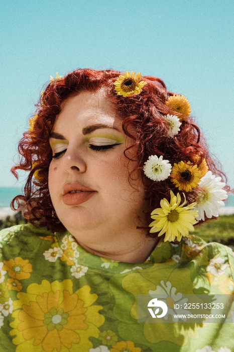 closeup of plus size woman with flowers in her hair eyes closed