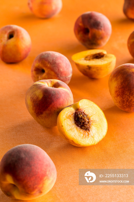 Peaches scattered against a bright peach background.