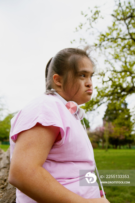 Young curvy girl with Down Syndrome relaxing after workout