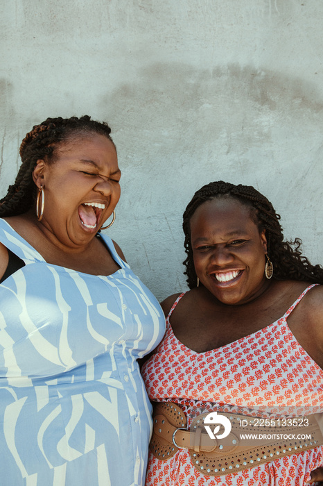 closeup of 2 African American women smiling and laughing together