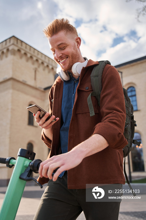 Man using a map app on mobile phone to find the right address in the city