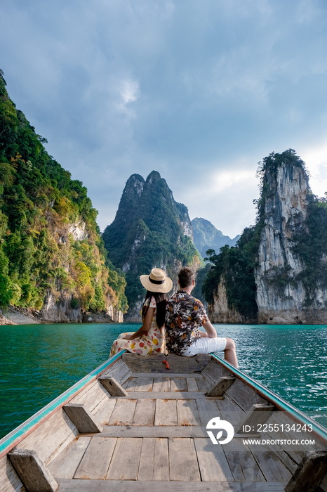 couple on longtail boat visiting Khao Sok national park in Phangnga Thailand, Khao Sok National Park with longtail boat for travelers, Cheow Lan lake, Ratchaphapha dam. man and woman mid age vacation