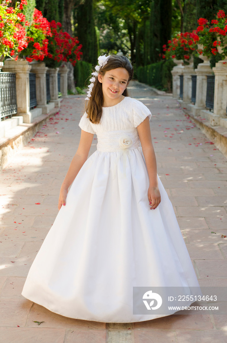 Little girl wear a beautiful white dress to take her first holy communion