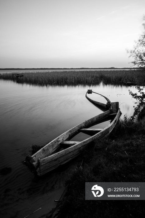 A canoe on the shore of the lake. A moody landscape. Liutsymer Lake. Polesie. Ukraine