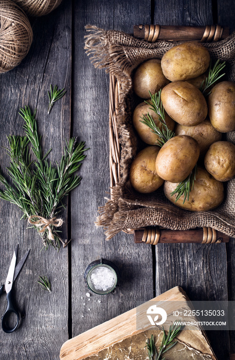 Potato with rosemary on rustic background