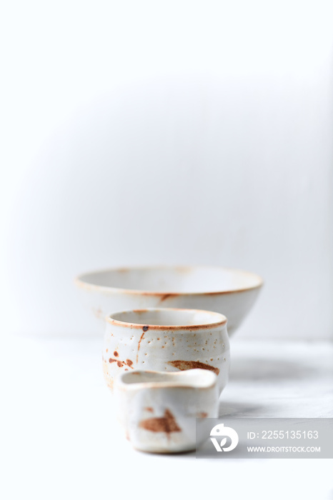 Traditional, handcrafted ceramic on bright wooden background. Soft focus. Copy space.