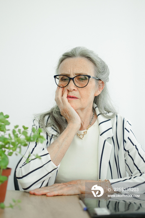 Closeup portrait of angry upset senior mature businesswoman at the office. Negative emotion, facial expression