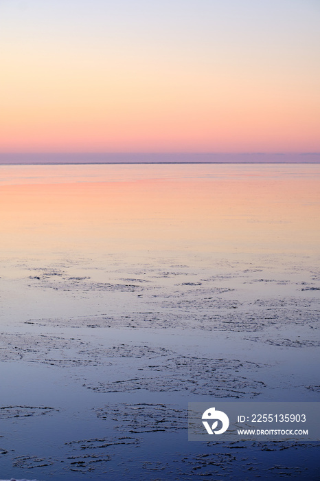 sunset afterglow at the sea with ice in the water