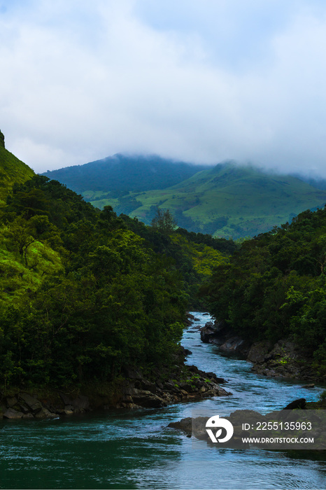 a body of water with a mountain in the background Captured in Kudremukh mountains