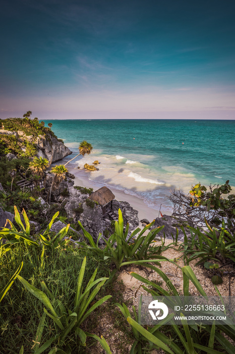 Sunset view at Mayan ruins of Tulum at the tropical coast. El Castillo Temple at paradise beach. Mayan ruins of Tulum, Quintana Roo, Mexico.