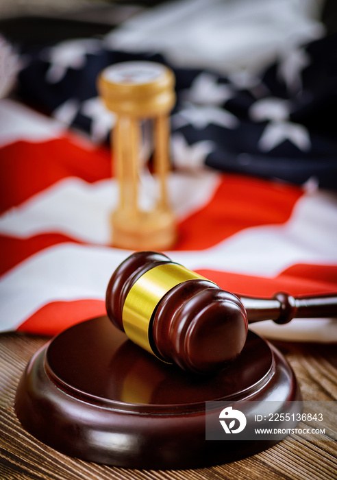 Wooden judge hammer on american flag Justice law