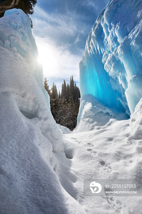 Frozen mountain waterfall and forest