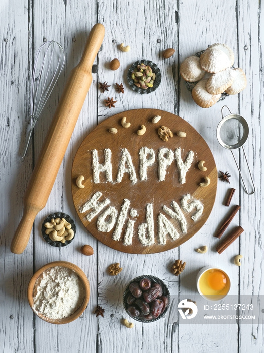 Happy holidays food background. Egg, flour and nuts are laid out on a dark wooden table