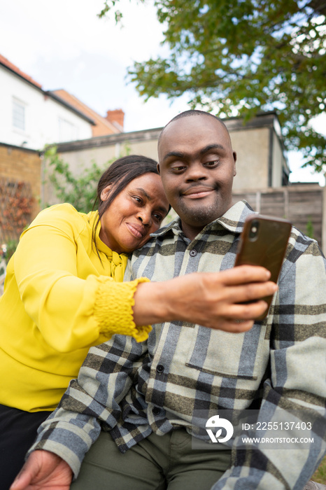 Mother and adult son with Down syndrome taking selfie