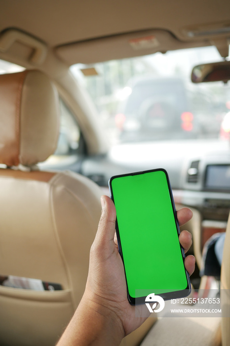 hand holding smart phone with empty screen in a car