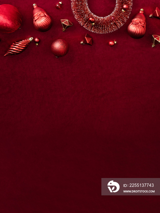 red christmas decoration bauble and ribbon on velvet red felt fabric  top view table backgorund.vertical layout