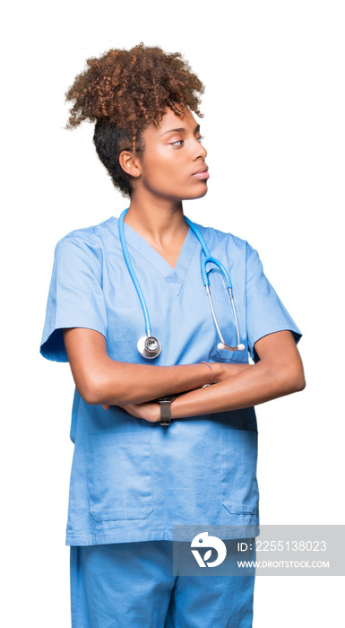 Young african american doctor woman over isolated background smiling looking to the side with arms crossed convinced and confident