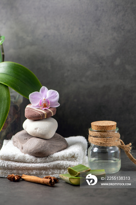 spa still life with towel and orchid  and aloe vera on gray cement background