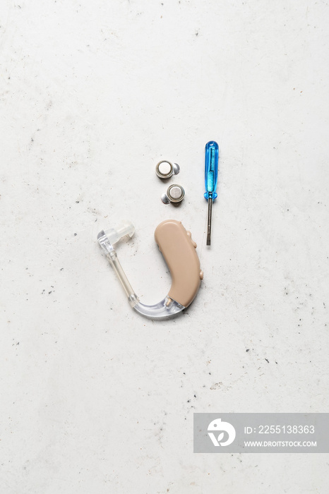 Hearing aid with accessories on white background