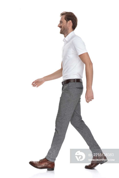 side view of a happy young man walking forward