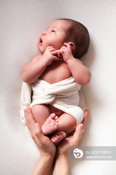 Mothercare newborn concept. Mother holding baby feet and heart