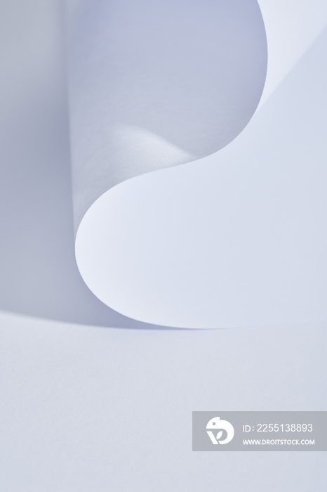 close up view of curved paper sheet on white background