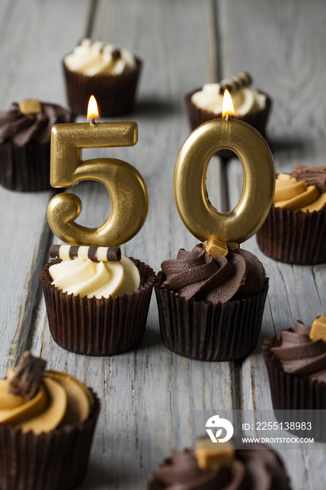 Number 50 celebration birthday cupcakes on a wooden background