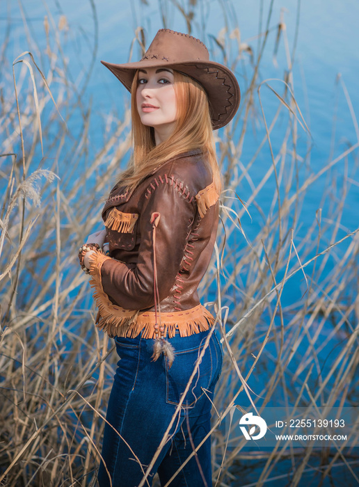 American style, girl in Leather cowboy jacket and hat, with nice modern figure and full hips