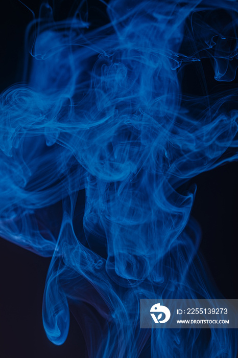 Abstract swirling smoke texture on black background