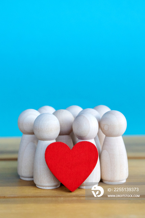 group of wooden figures with a red heart and blue background