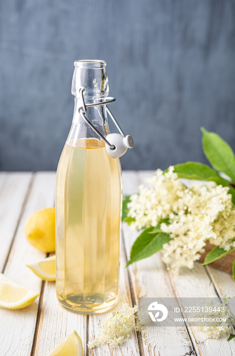 Delicious healthy refreshing beverage, sweet elderflower syrup or cordial in a glass bottle