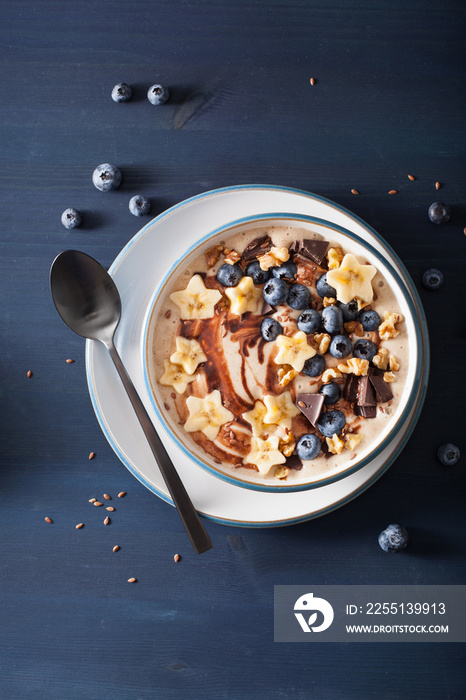 healthy banana smoothie bowl with blueberry chocolate walnuts