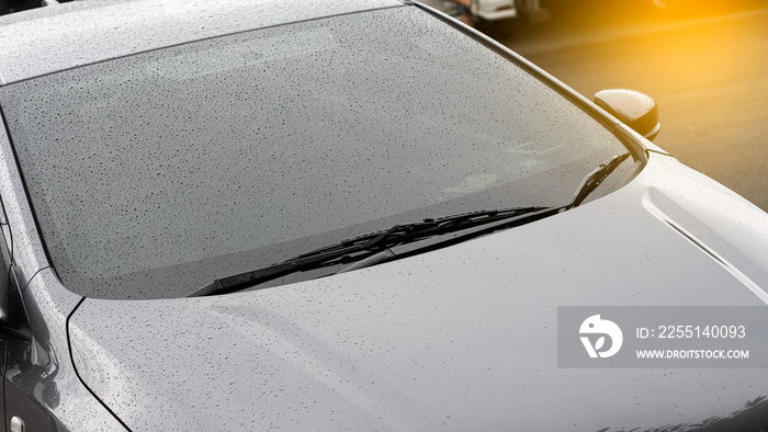 The front view of the black car with rain drops on top