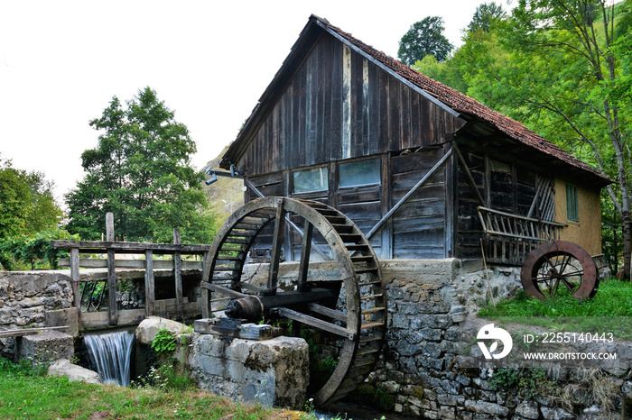 An old wooden mill on a stream