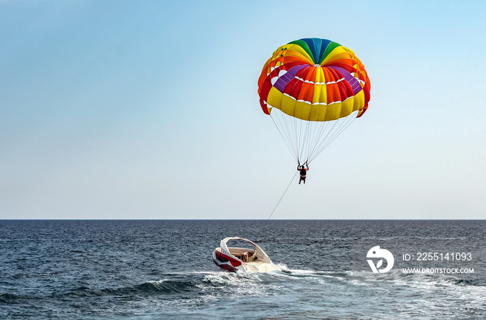 Parasailing colorful parachute motorboat