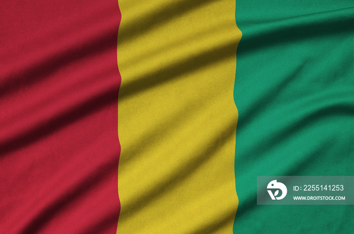 Guinea flag  is depicted on a sports cloth fabric with many folds. Sport team banner