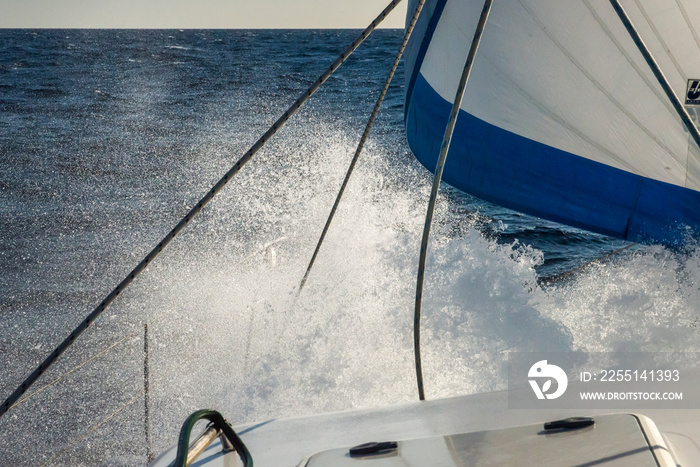 Sailing in strong wind with crashing waves on deck