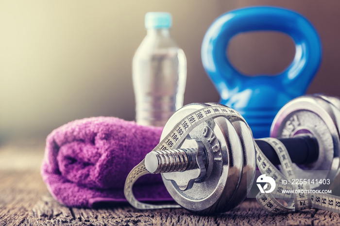 Fitness Equipment. Kettlebell  dumbbells towel water and measuring tape.