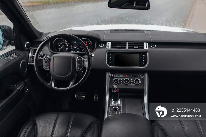 Expensive suv car interior with steering wheel, multimedia dashboard and gearbox handle