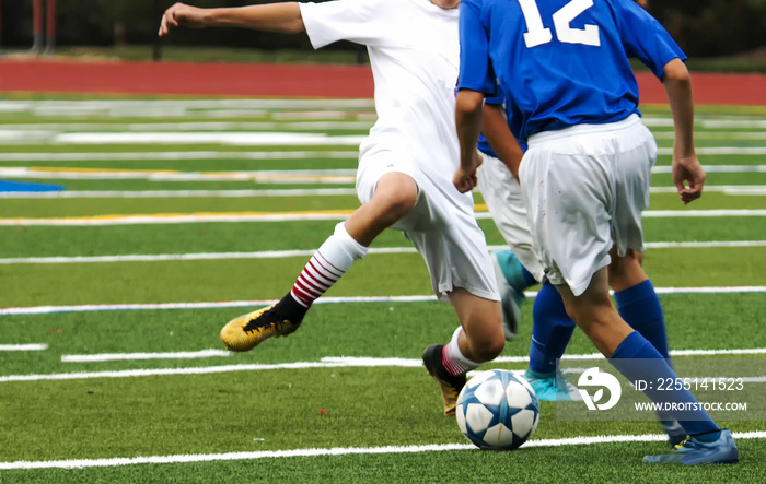 Two boys fight for soccdr ball during game