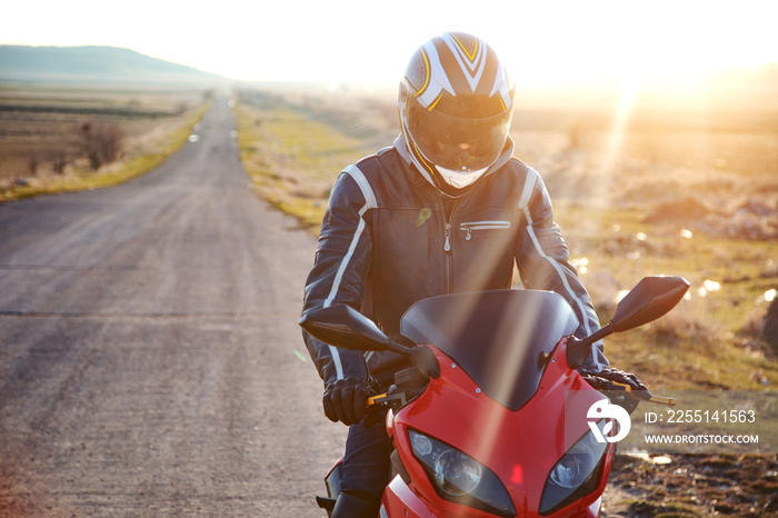 Biker stands on the road