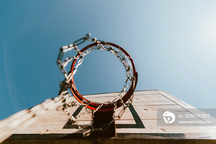 old basketball hoop against blue sky