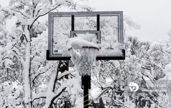 Basketball hoop with snow in it after a storm