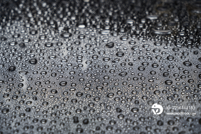 Rain drops on glass background. Raindrops on glass with reflection