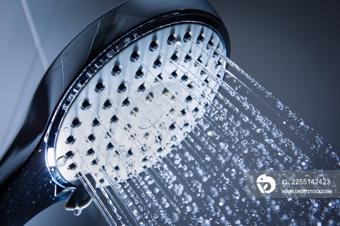 Modern luxury shower head splashing a water in stop motion, space in the right side for copy space.