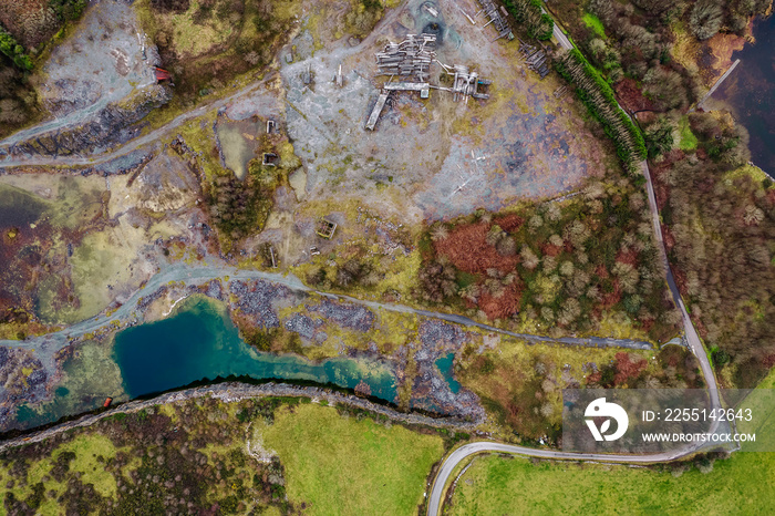 Aerial top down view on an old abandoned open quarry with pool of water. Stone for construction industry. Nature scene. County Galway, Ireland. Industrial impact on ecology and environment.