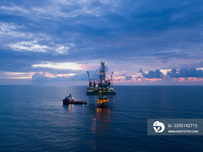 Aerial view offshore drilling rig (jack up rig) at the offshore location during sunset